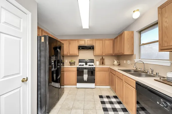 a kitchen with a sink stove and refrigerator