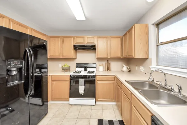 a kitchen with a sink cabinets and stainless steel appliances