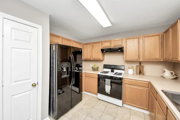 a kitchen with a stove sink and refrigerator