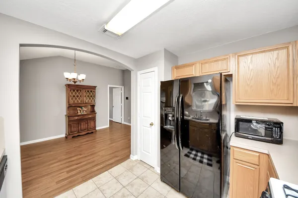 a kitchen with stainless steel appliances a refrigerator and a stove top oven