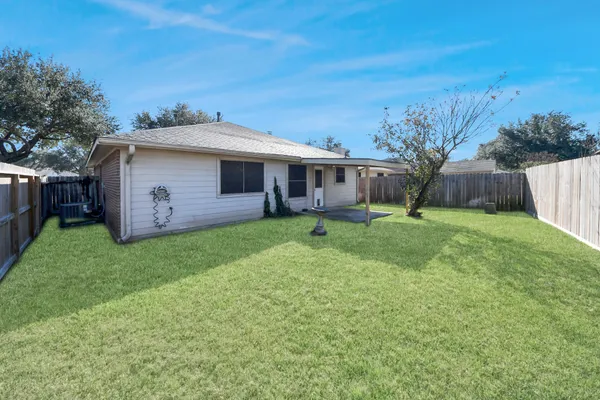 a view of a house with a yard and sitting area