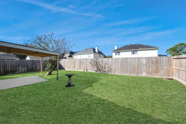 a view of a backyard with a garden and entertaining space