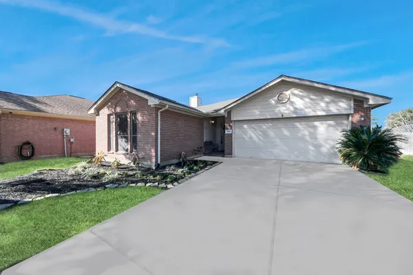 a front view of a house with a garden and plants