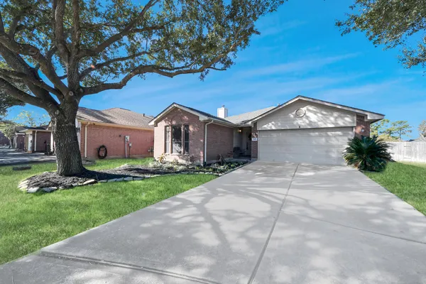 a front view of a house with a garden and yard