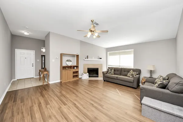 a living room with furniture and a fireplace