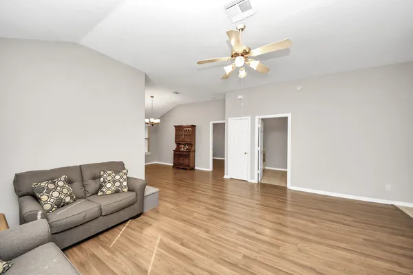 a living room with furniture and a chandelier