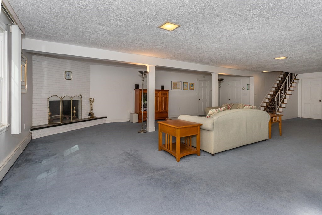 24 Mohawk Road Canton, MA 02021 - Photo 25 of 34 a bedroom with furniture and a fireplace