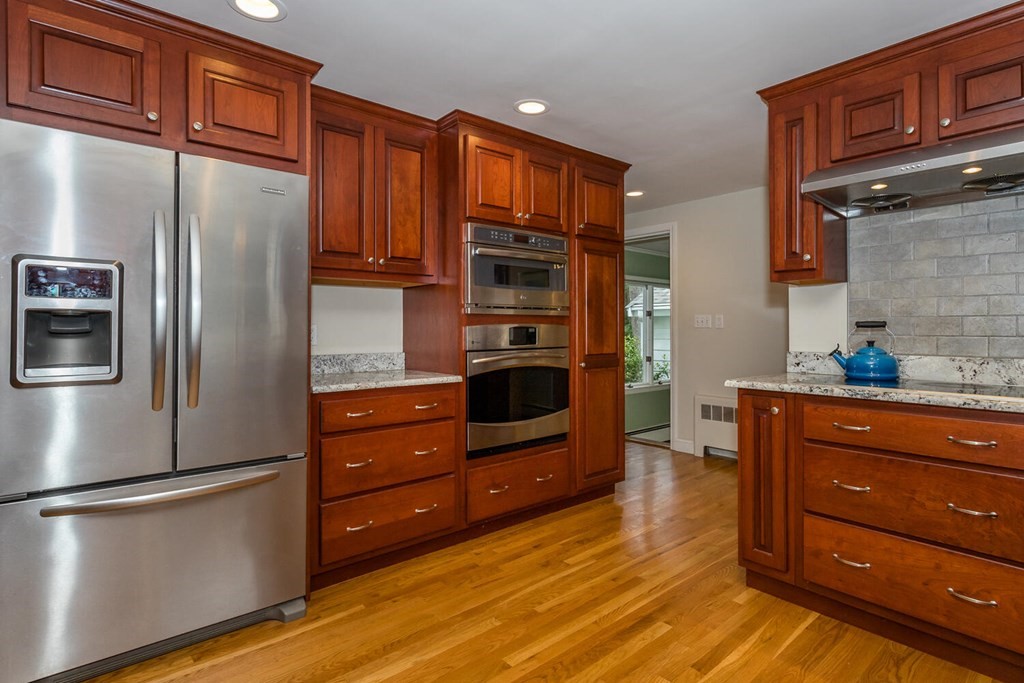 24 Mohawk Road Canton, MA 02021 - Photo 10 of 34 a kitchen with stainless steel appliances granite countertop a refrigerator and a stove top oven