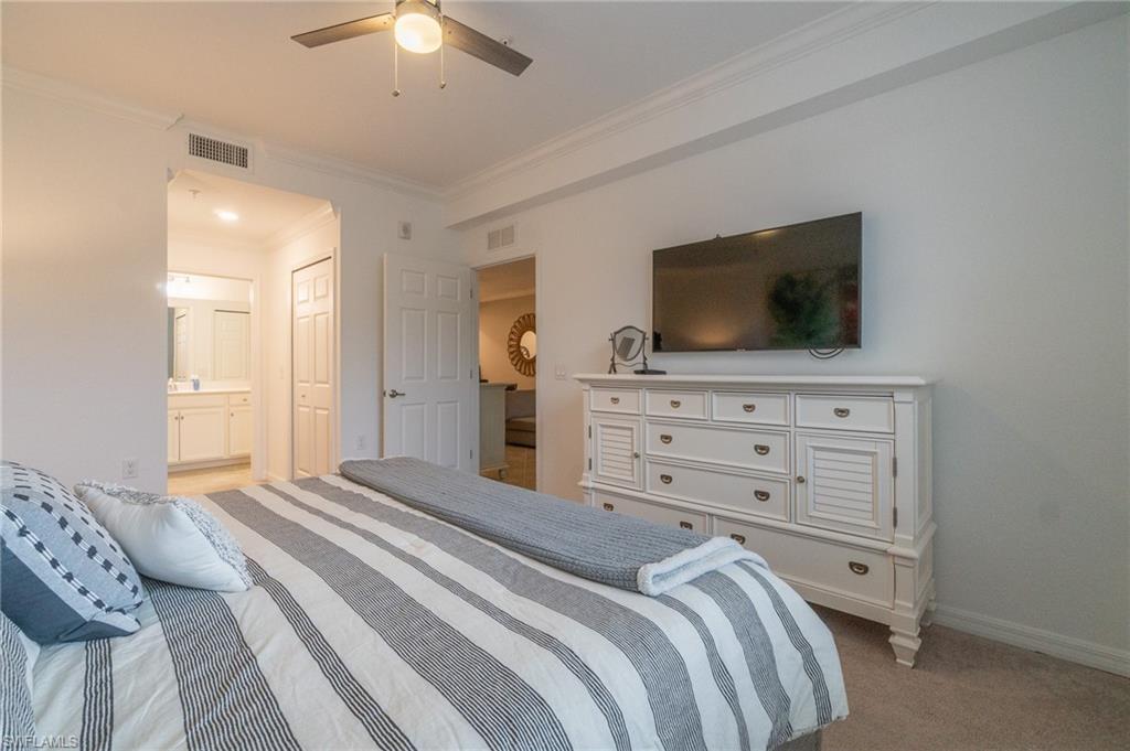 9596 Trevi Court, Unit 5414 Naples, FL 34113 - Photo 12 of 34 a bedroom with a bed and a flat screen tv