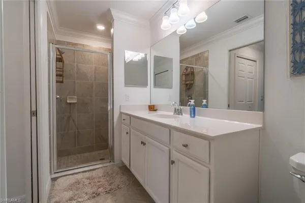 a bathroom with a shower sink and mirror