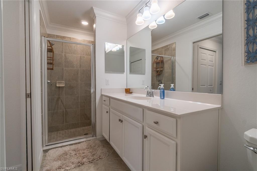 9596 Trevi Court, Unit 5414 Naples, FL 34113 - Photo 13 of 34 a bathroom with a shower sink and mirror