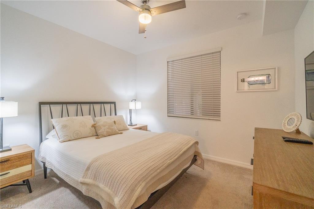 9596 Trevi Court, Unit 5414 Naples, FL 34113 - Photo 15 of 34 a bedroom with a bed and a window