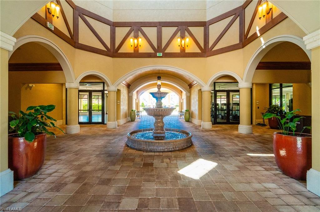 9596 Trevi Court, Unit 5414 Naples, FL 34113 - Photo 23 of 34 a front view of a house with a garden