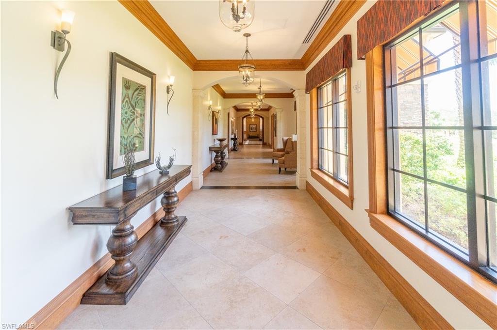 9596 Trevi Court, Unit 5414 Naples, FL 34113 - Photo 32 of 34 a living room with furniture and a large window