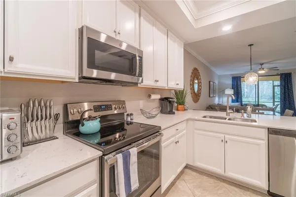 a kitchen with a sink a stove and cabinets