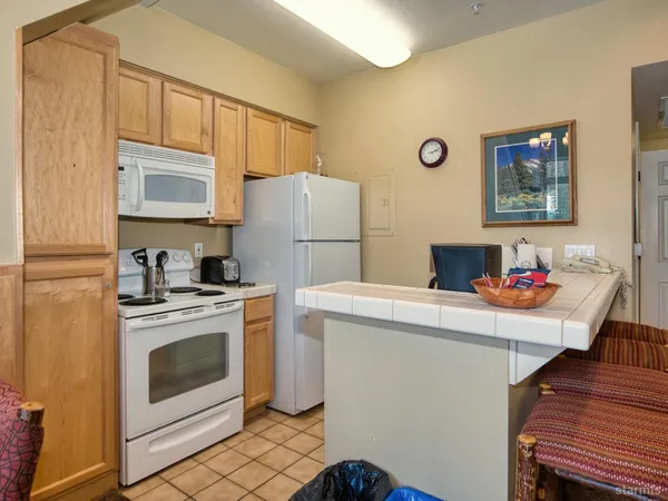 a kitchen with a stove a refrigerator and a sink