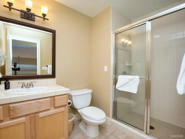 a bathroom with a toilet sink and a mirror