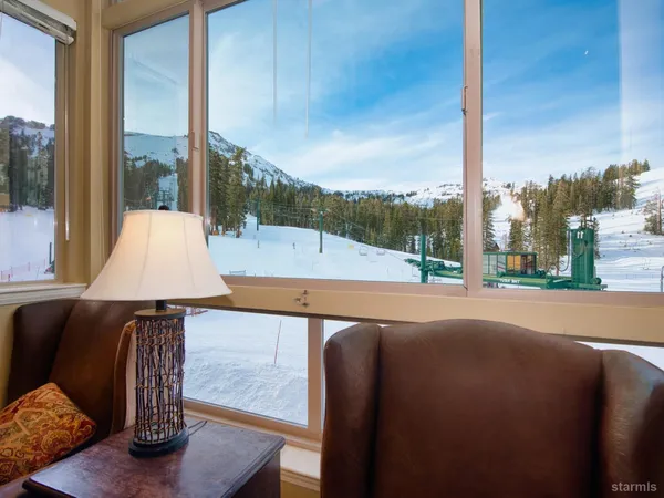 a swimming pool with outdoor seating and city view