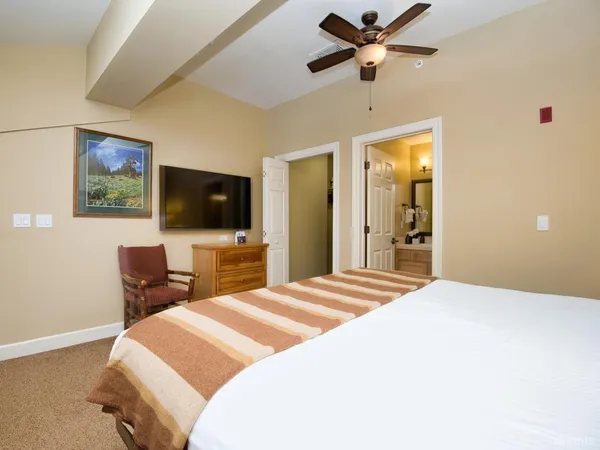 a bedroom with a bed and a flat screen tv