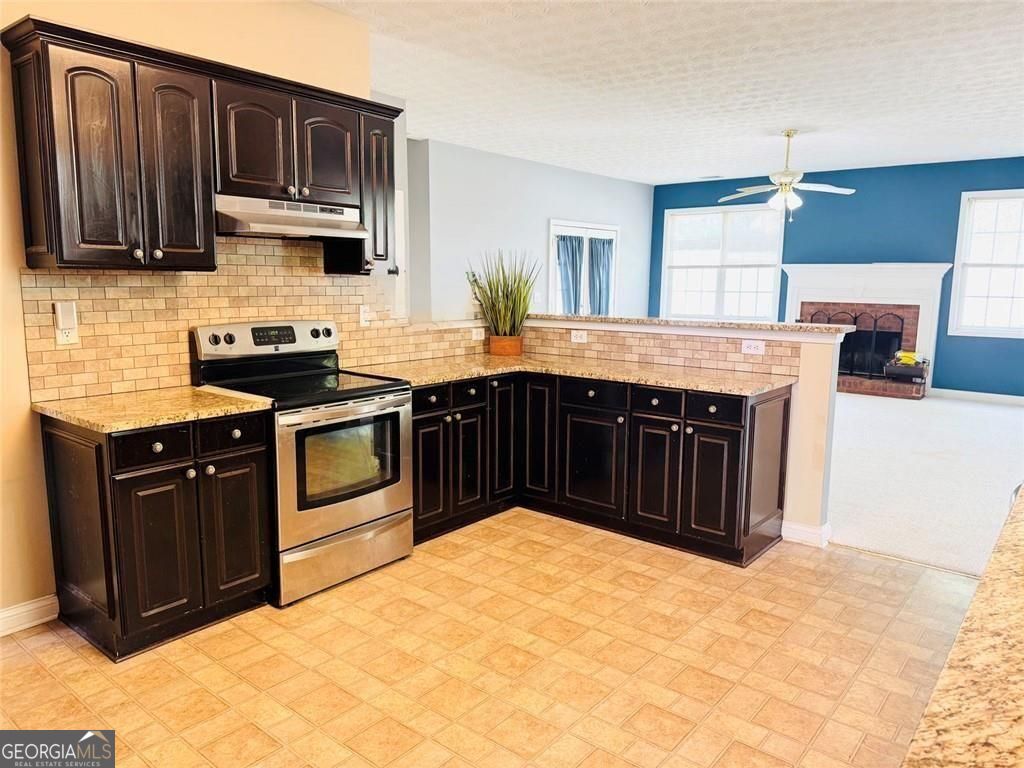 543 Saddle Ridge Drive Bethlehem, GA 30620 - Photo 11 of 36 a kitchen with stainless steel appliances granite countertop a stove a sink dishwasher and a refrigerator