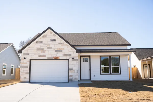 a front view of a house with a yard