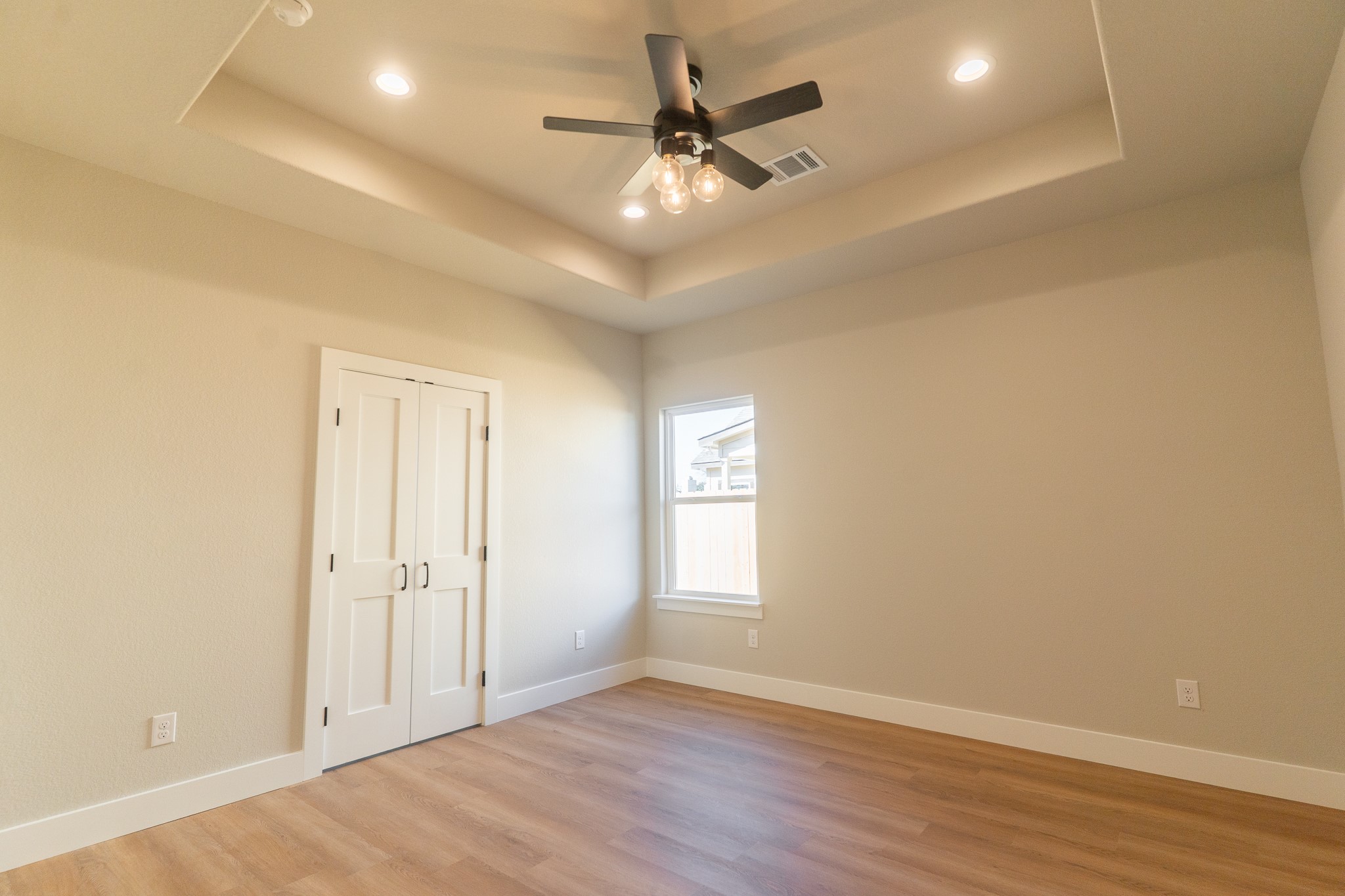 313 String Prairie Way Smithville, TX 78957 - Photo 11 of 18 an empty room with wooden floor and windows