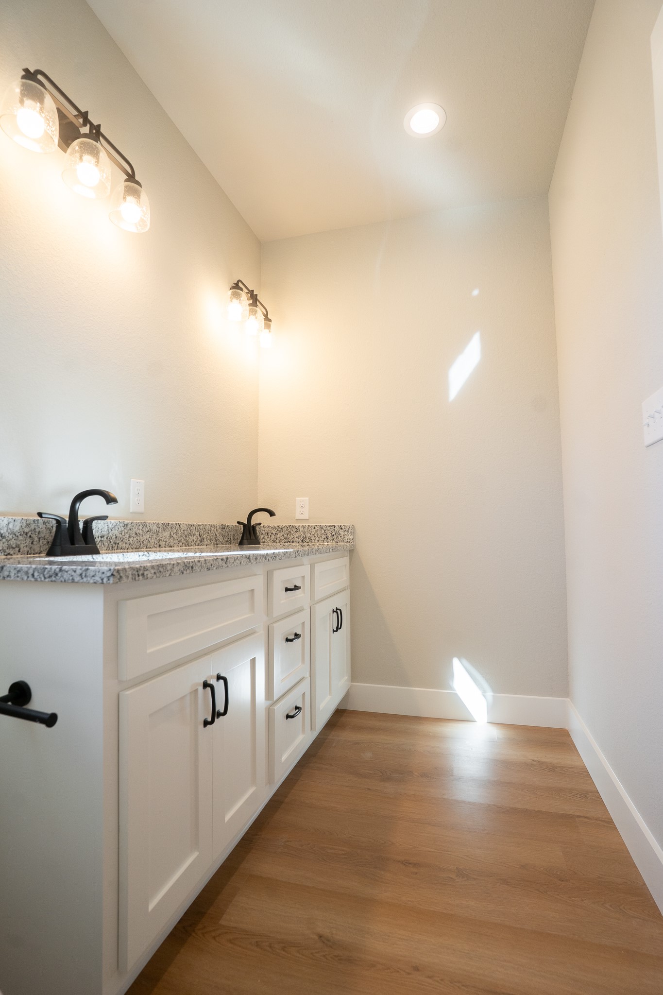 313 String Prairie Way Smithville, TX 78957 - Photo 12 of 18 a view of storage and utility room with wooden floor