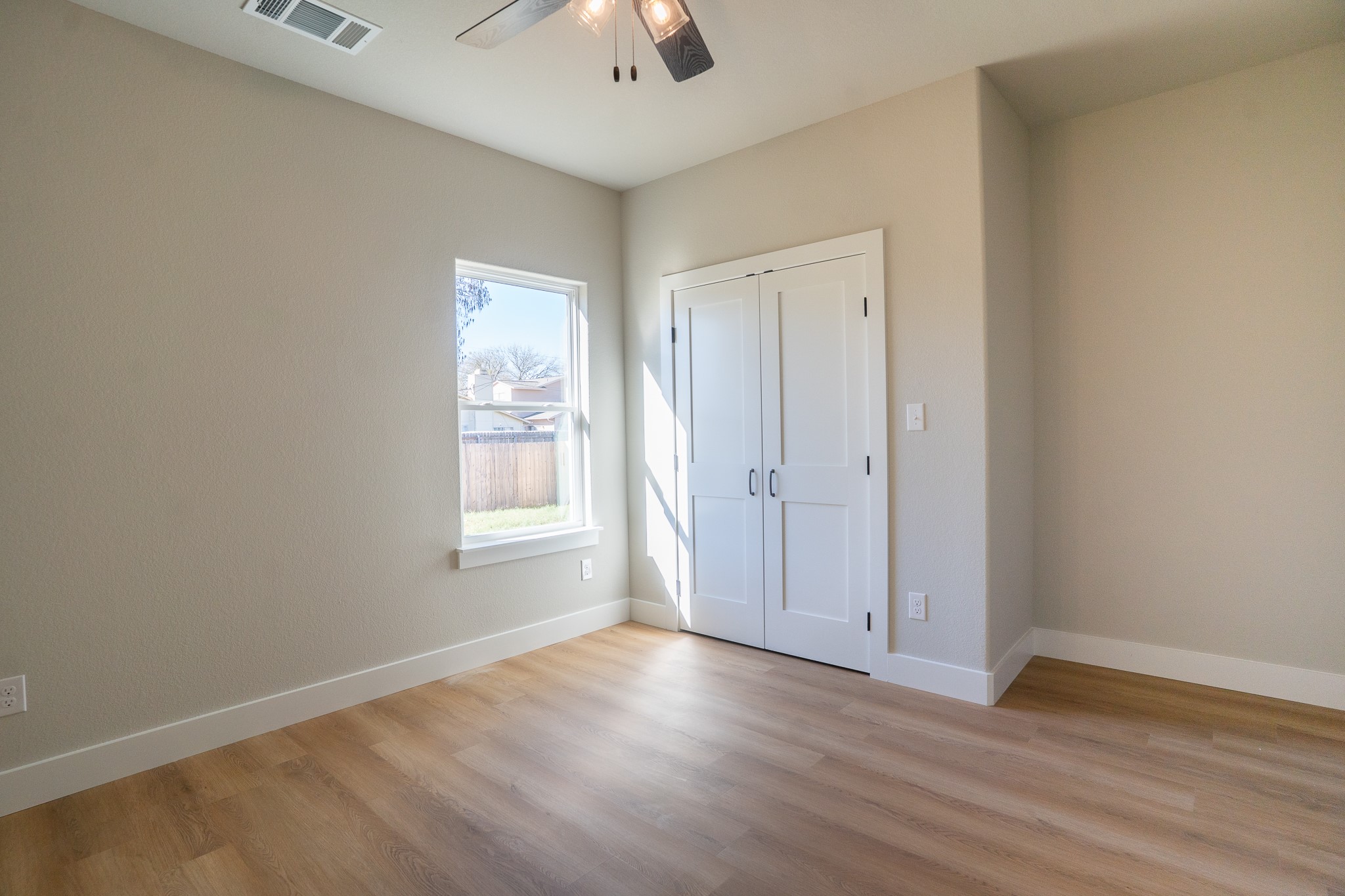 313 String Prairie Way Smithville, TX 78957 - Photo 15 of 18 an empty room with wooden floor and windows