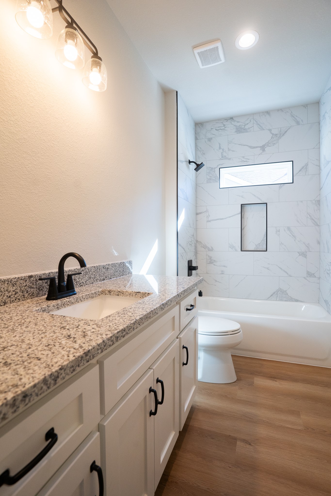 313 String Prairie Way Smithville, TX 78957 - Photo 16 of 18 a bathroom with a granite countertop sink mirror vanity and toilet