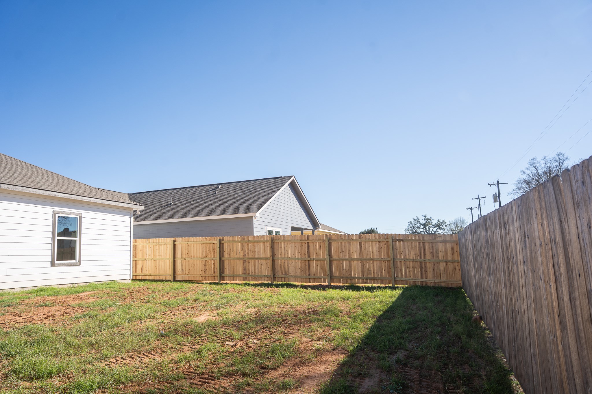 313 String Prairie Way Smithville, TX 78957 - Photo 18 of 18 a view of an empty room with wooden floor and a fence