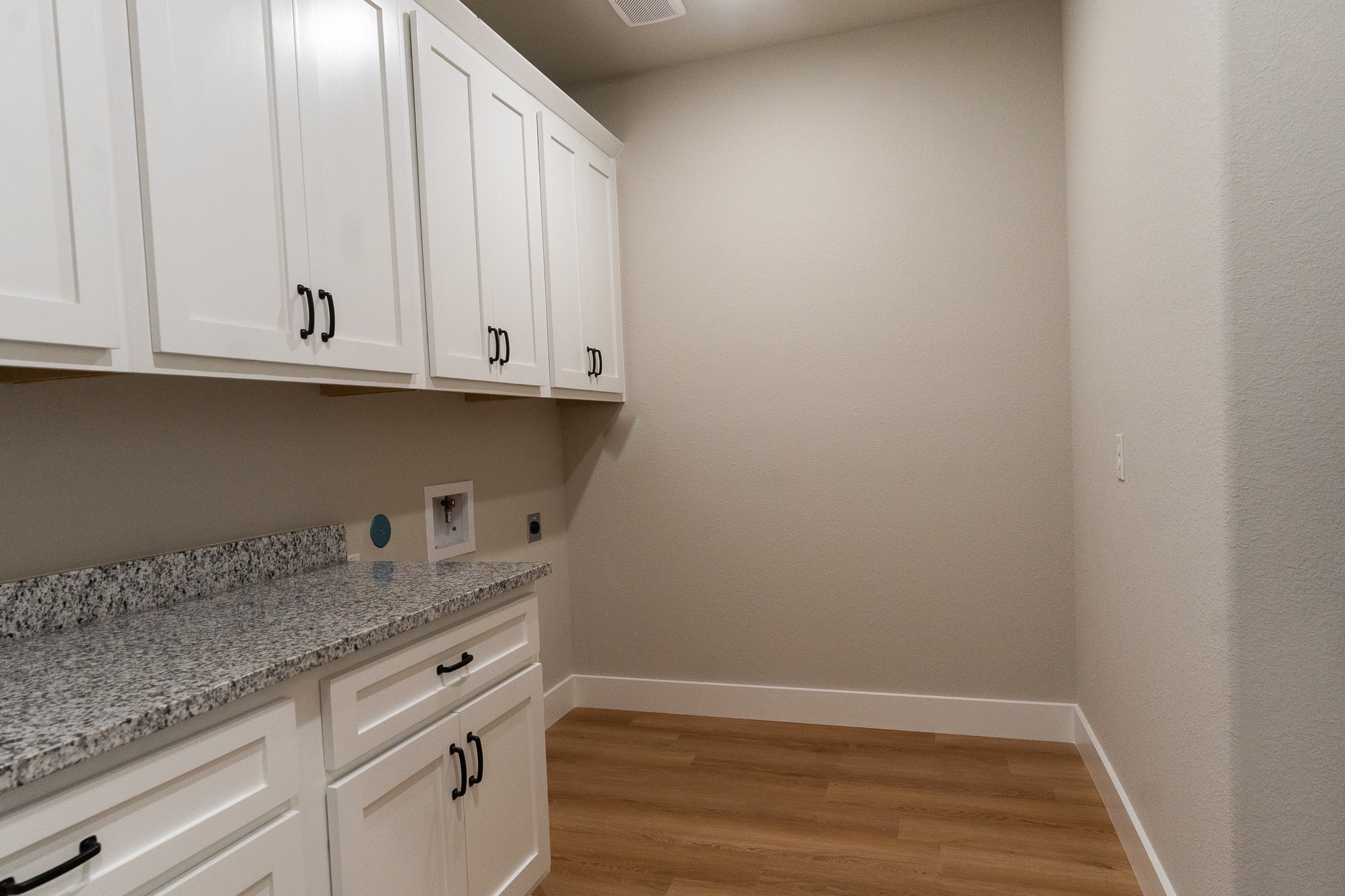 313 String Prairie Way Smithville, TX 78957 - Photo 8 of 18 a view of cabinets and wooden floor