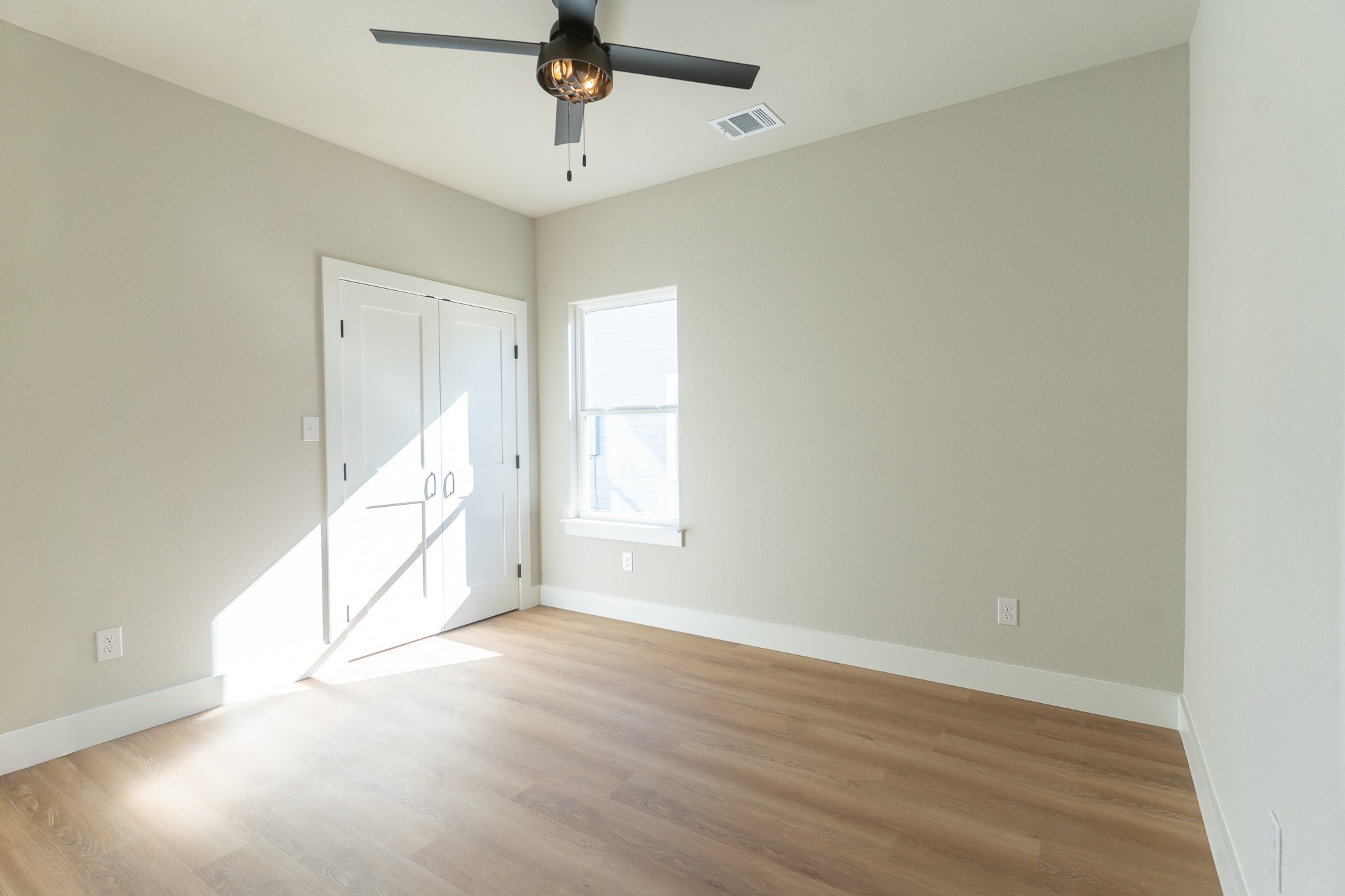 313 String Prairie Way Smithville, TX 78957 - Photo 9 of 18 an empty room with wooden floor and windows