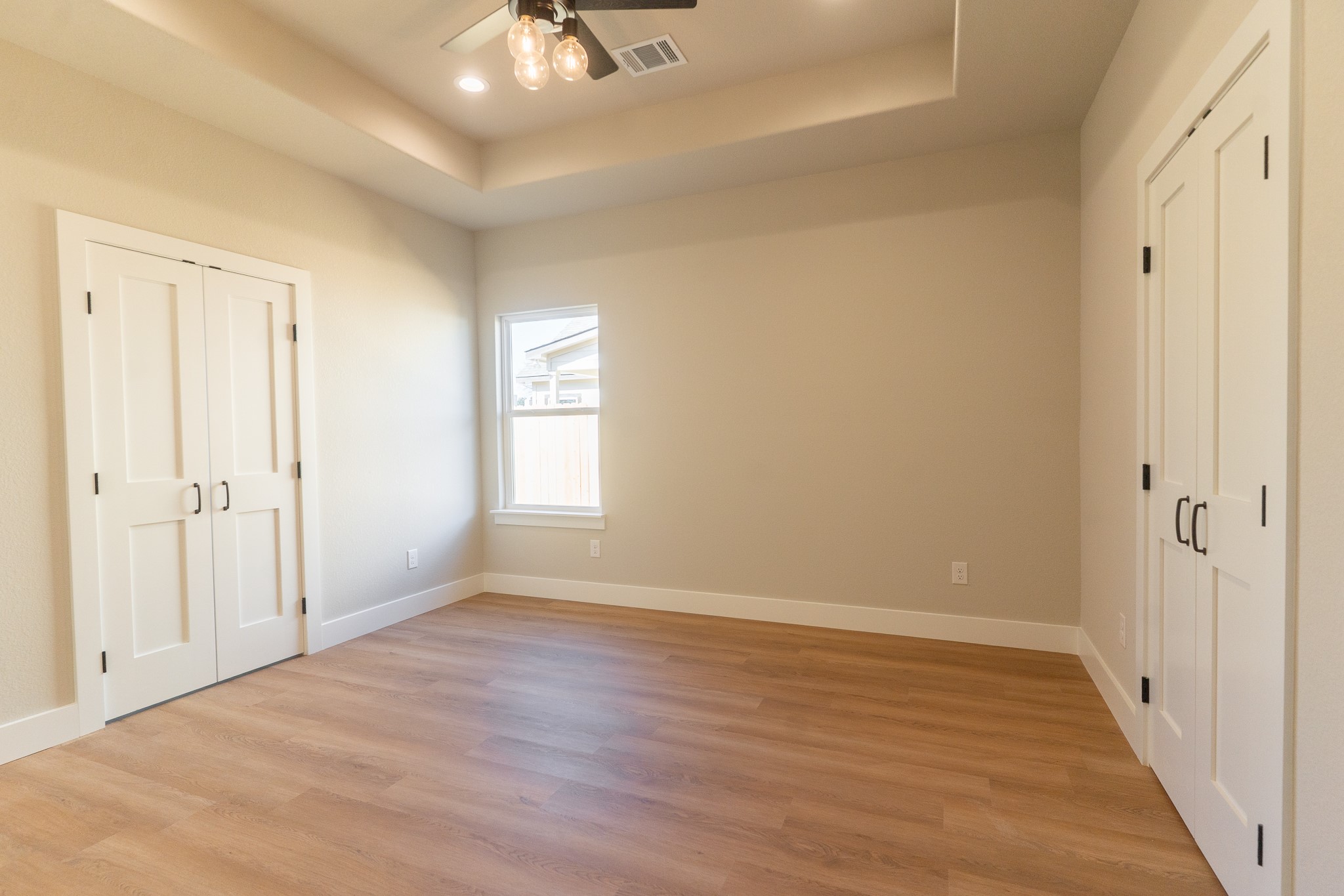 313 String Prairie Way Smithville, TX 78957 - Photo 10 of 18 a view of an empty room with wooden floor