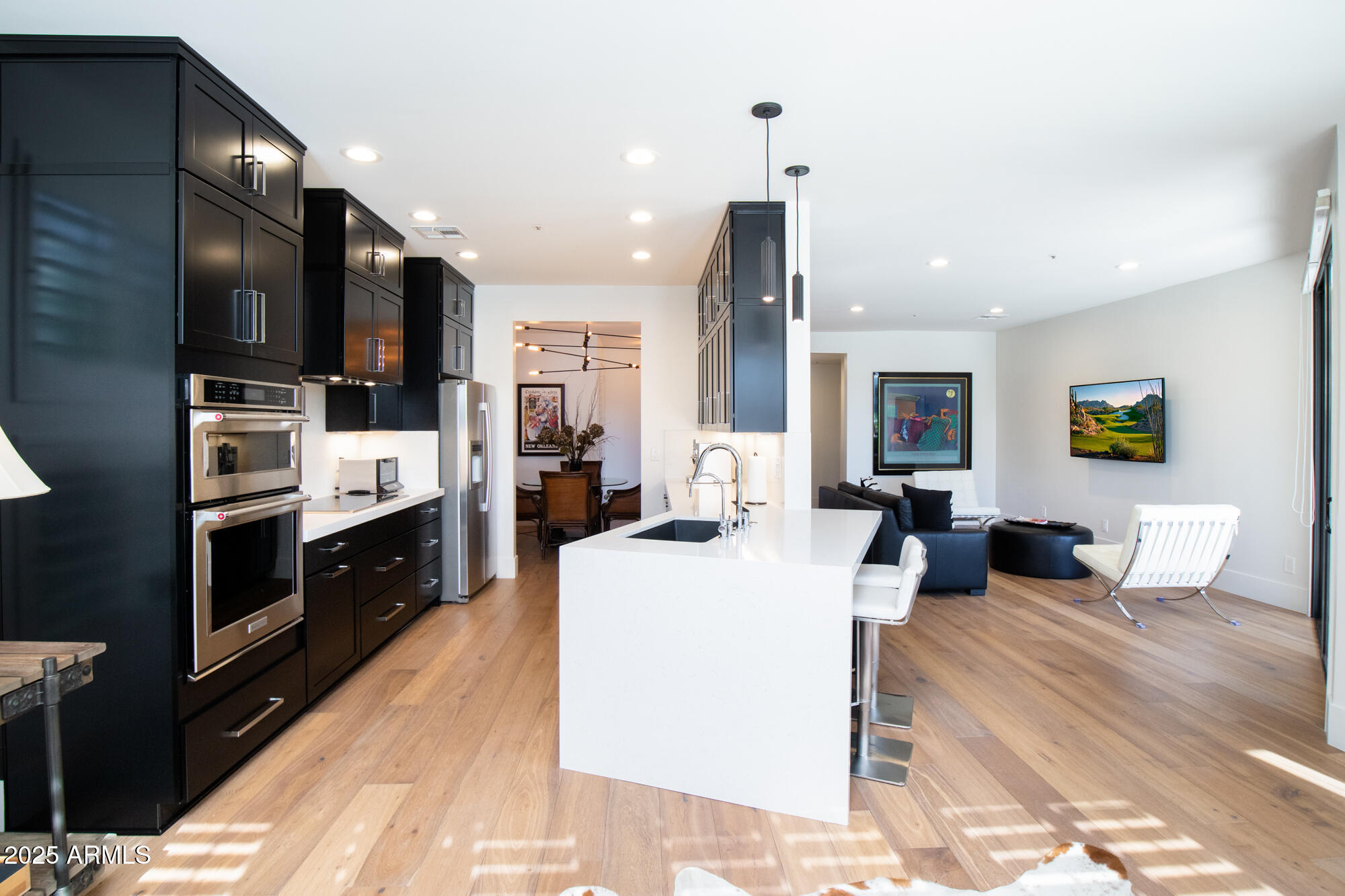 7700 East Gainey Ranch Road, Unit 125 Scottsdale, AZ 85258 - Photo 46 of 46 a large white kitchen with stainless steel appliances