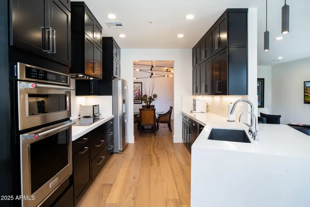 a large white kitchen with stainless steel appliances