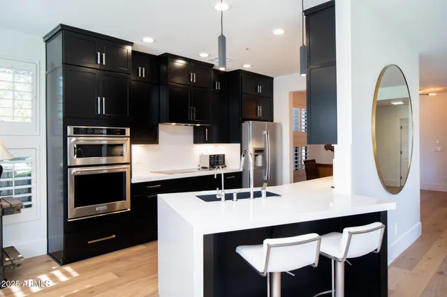 a kitchen with kitchen island a counter space and stainless steel appliances
