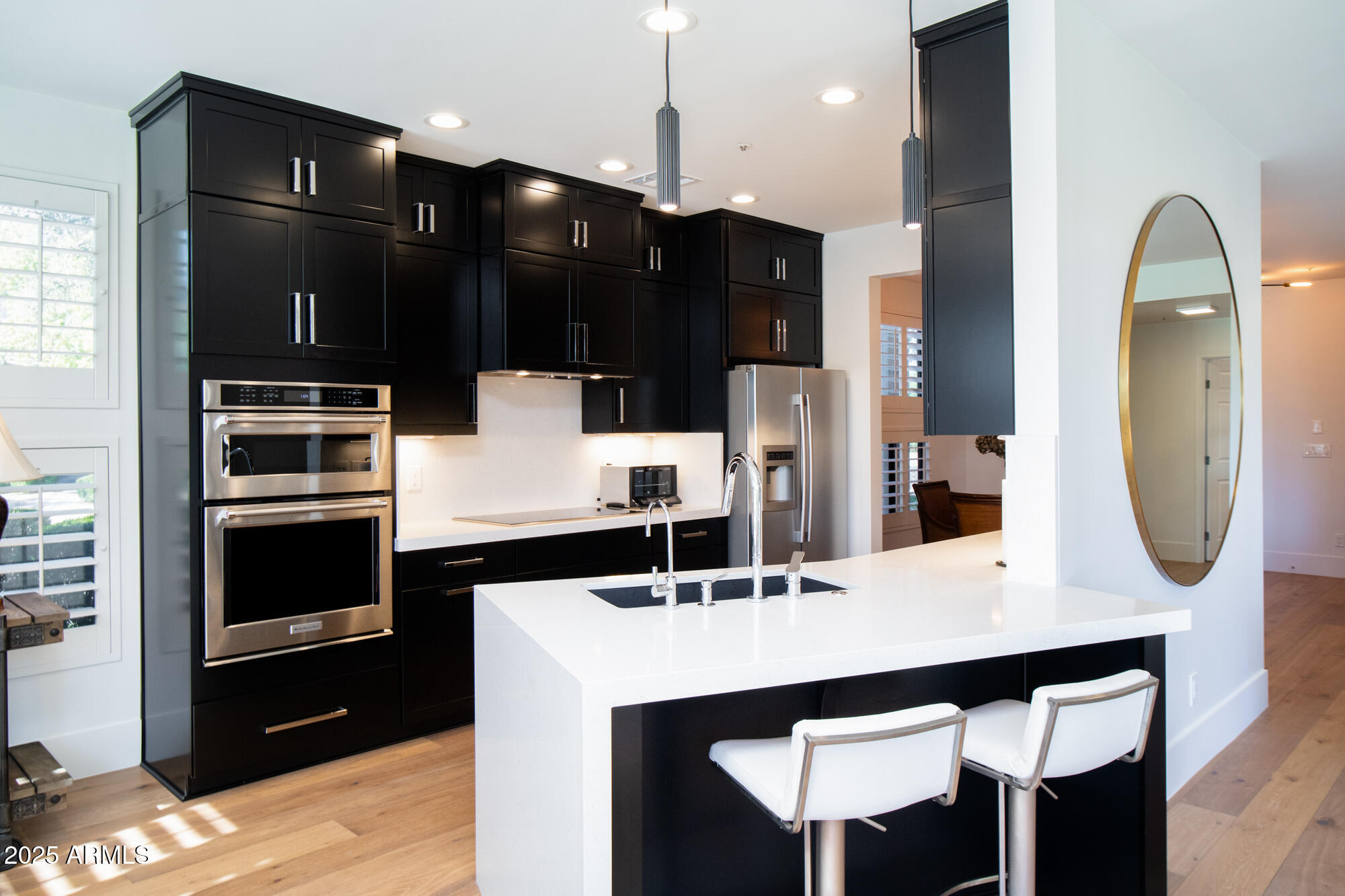 7700 East Gainey Ranch Road, Unit 125 Scottsdale, AZ 85258 - Photo 14 of 46 a kitchen with a table chairs and refrigerator