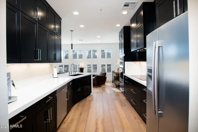 a kitchen with a table chairs and refrigerator