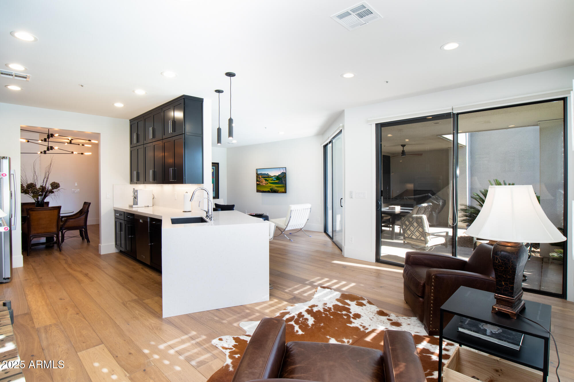 7700 East Gainey Ranch Road, Unit 125 Scottsdale, AZ 85258 - Photo 16 of 46 a living room with furniture and a flat screen tv