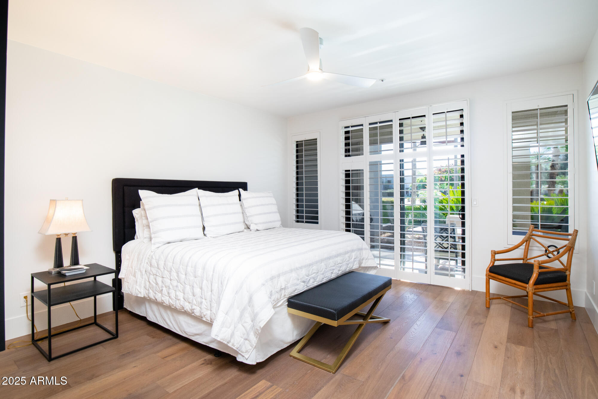 7700 East Gainey Ranch Road, Unit 125 Scottsdale, AZ 85258 - Photo 17 of 46 a bedroom with a bed and a large window