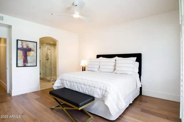 a bedroom with a bed and a large window