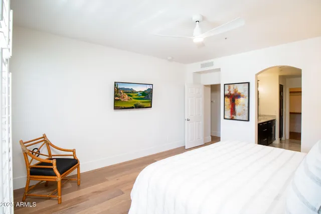 a bedroom with a bed and wooden floor