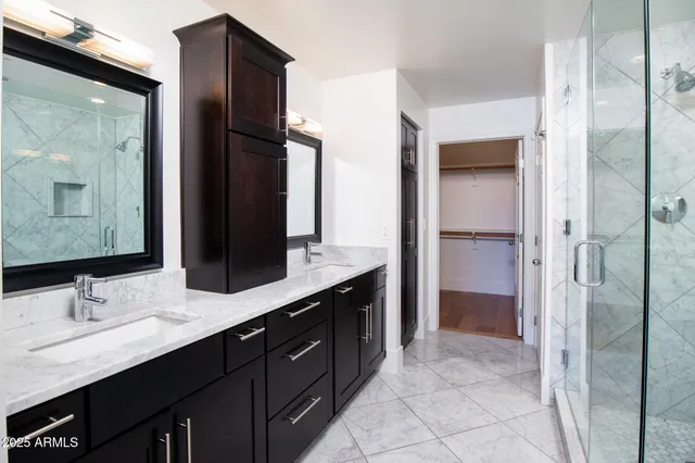 a en suite bathroom with a granite countertop sink and a mirror