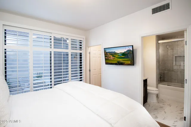 a bedroom with a bed and a window