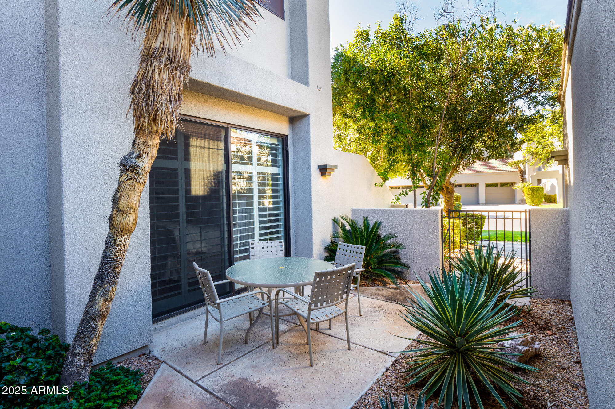 7700 East Gainey Ranch Road, Unit 125 Scottsdale, AZ 85258 - Photo 25 of 46 a view of a backyard with a garden and patio