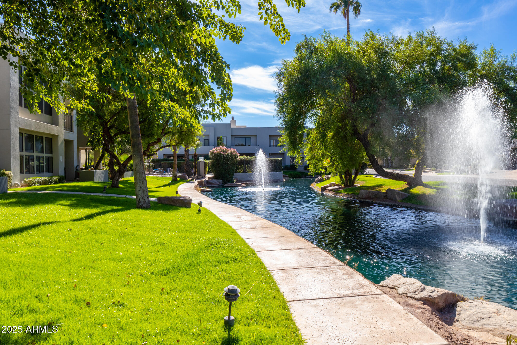 7700 East Gainey Ranch Road, Unit 125 Scottsdale, AZ 85258 - Photo 29 of 46 a view of a backyard with swimming pool