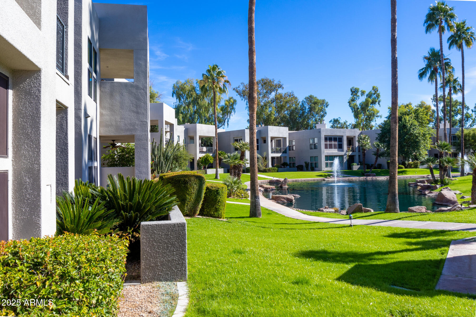 7700 East Gainey Ranch Road, Unit 125 Scottsdale, AZ 85258 - Photo 30 of 46 a view of a house with a swimming pool