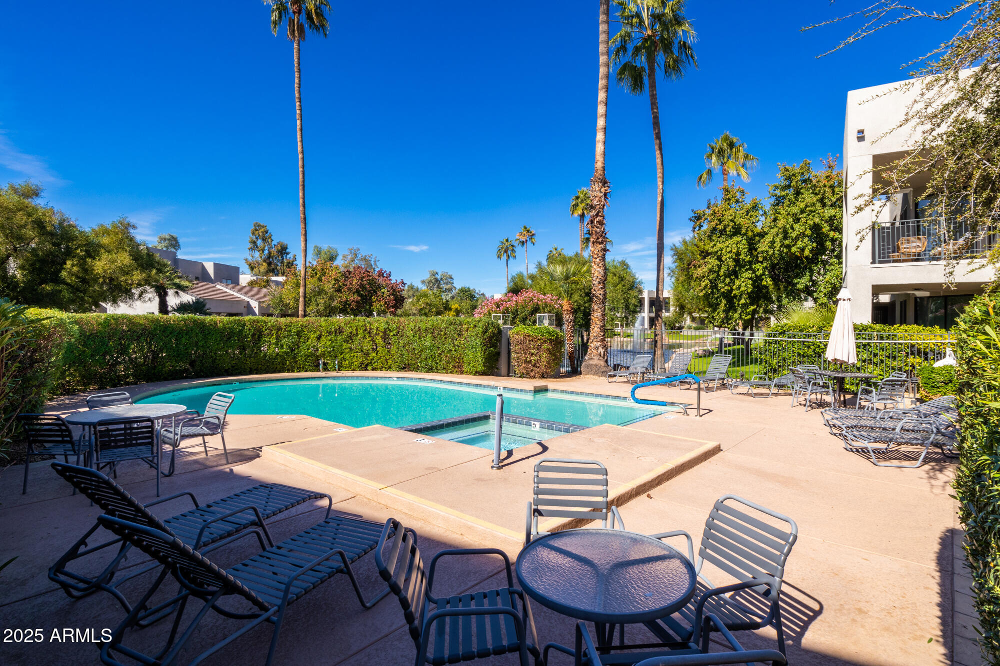 7700 East Gainey Ranch Road, Unit 125 Scottsdale, AZ 85258 - Photo 32 of 46 a view of a chairs and table in patio with a fire pit