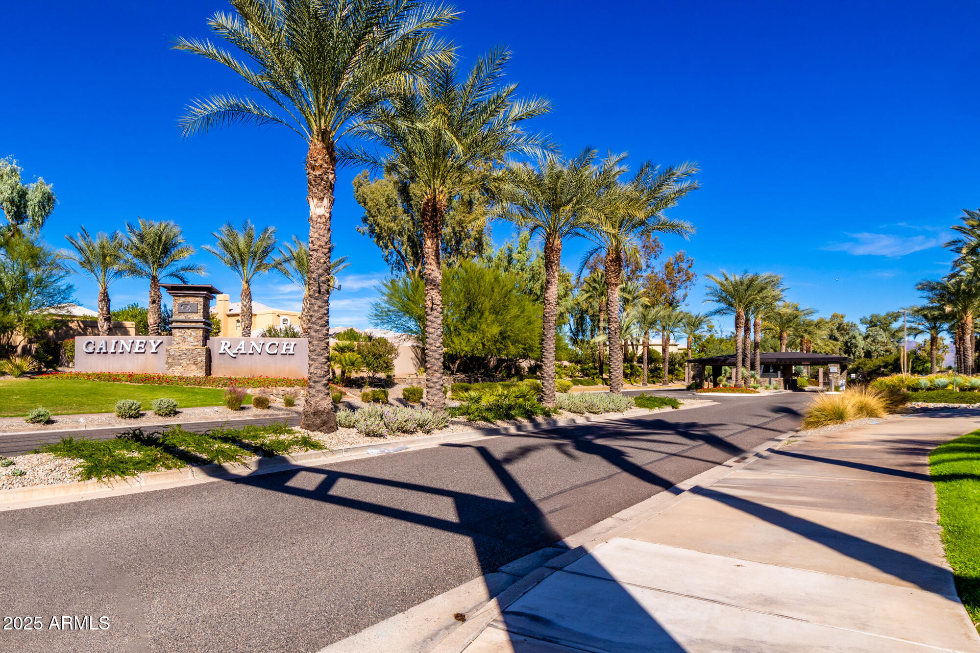 7700 East Gainey Ranch Road, Unit 125 Scottsdale, AZ 85258 - Photo 35 of 46 a view of a street with cars parked on the roadside