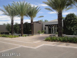 7700 East Gainey Ranch Road, Unit 125 Scottsdale, AZ 85258 - Photo 38 of 46 a view of a house with a yard and palm trees